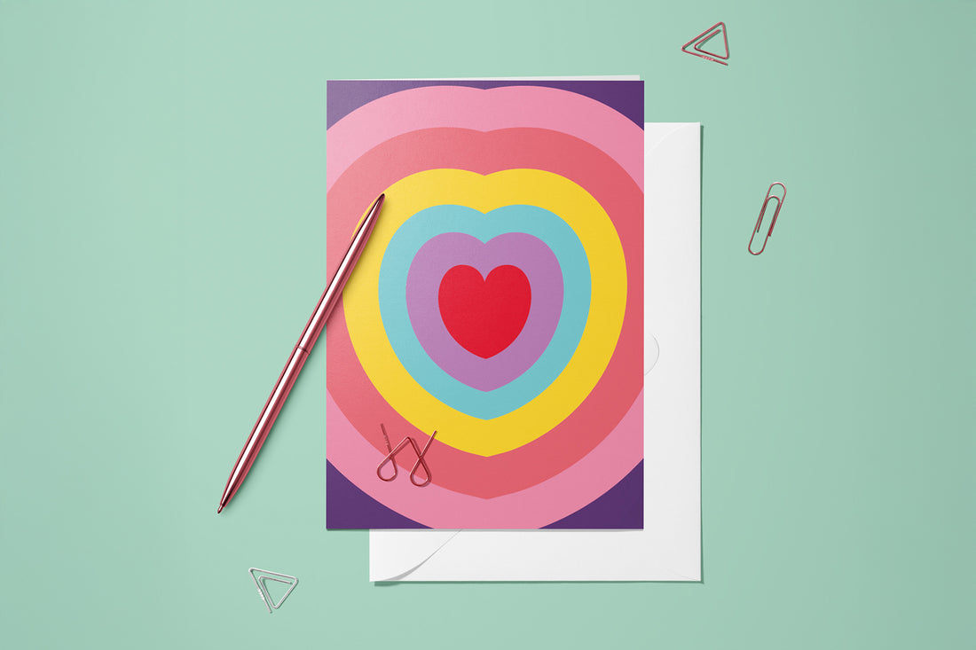 Carte Cœur Arc-en-ciel du pack thème Amour 3, posée avec un stylo doré et son enveloppe