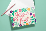 Carte Joyeux Noël du pack thème Noël, message calligraphié entouré de feuillages, avec un stylo doré