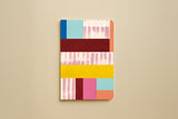 Carnet géométrique du trio papeterie coloré, couverture à aplats bleus, rouges et roses