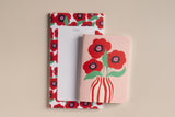 Pack Coquelicot présenté à plat : bloc-notes et carnet de poche illustrés de coquelicots rouges