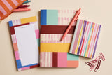 Pack Mondrian trio papeterie déballé à plat : bloc-notes, carnet géométrique et carnet rayé